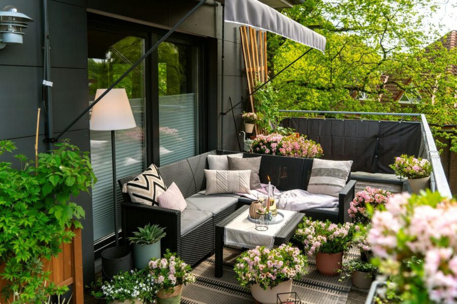 Cozy summer balcony seating plants lanterns