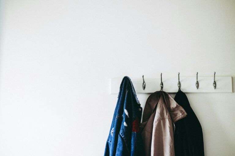 Trench coat hanging wall folded denim jacket chair