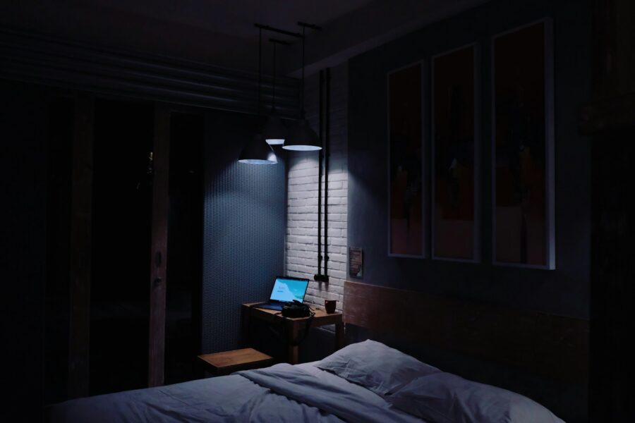 Student dorm room desk lamp laptop books