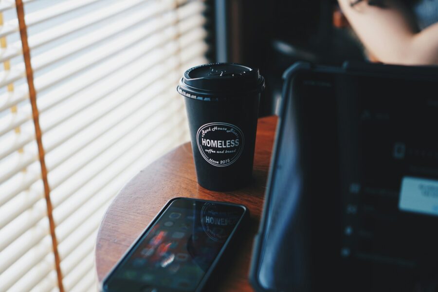 Commuter backpack train coffee mug phone