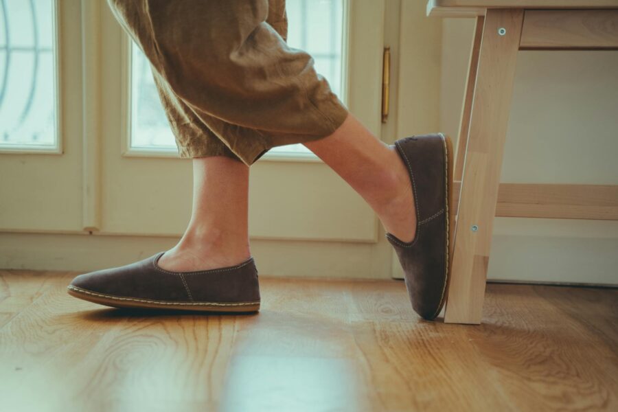 Neutral leather loafers wooden floor close