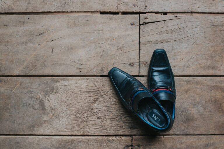 Neutral leather loafers wooden floor close