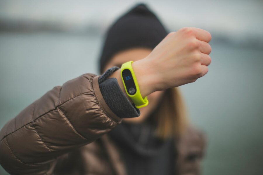 Fitness tracker wristband close hand running shoes