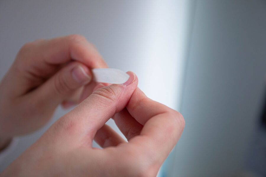 Hands applying cuticle