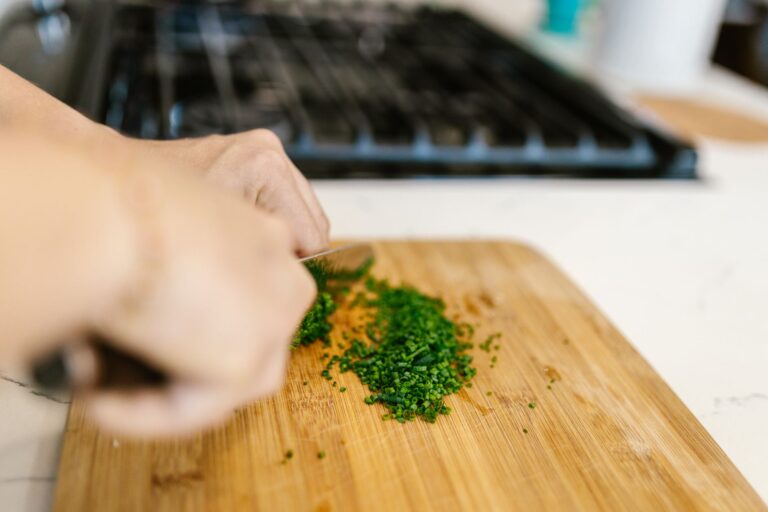 Hands chopping vegetables